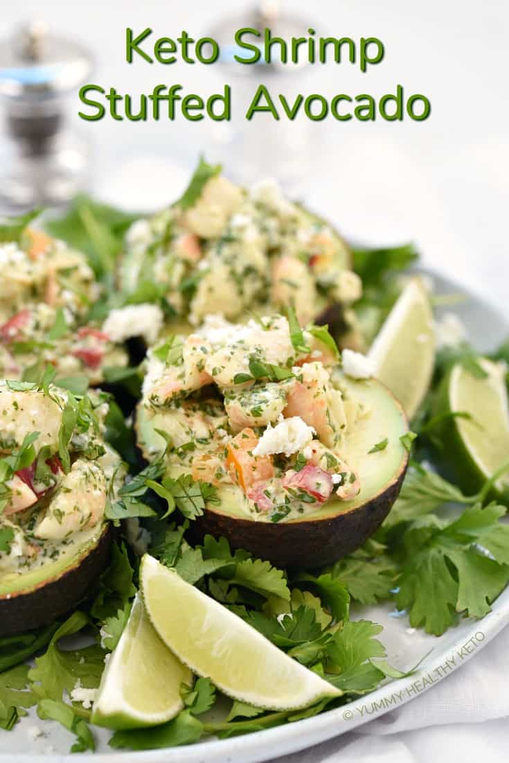 Three avocados cut in half and filled with shrimp stuffing.